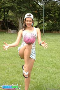 Cute Latina Girl Bouncing Ball On Knee